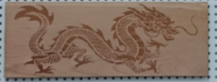 Shallow engraved dragon on cherry wood.